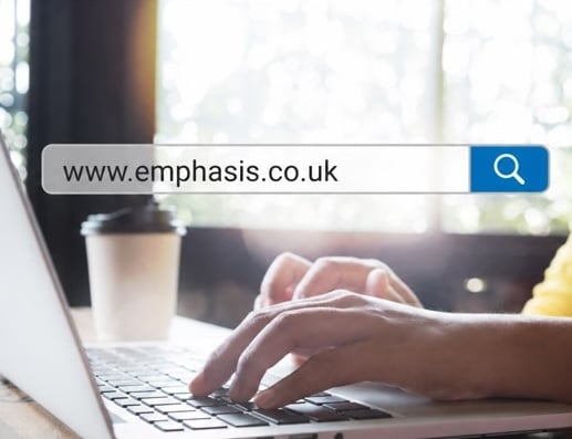 hands typing on laptop with superimposed search bar showing 'www.emphasis.co.uk'